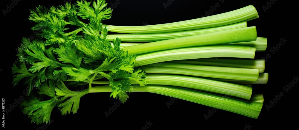 Aufkleber celery sticks arranged on a black background for a copy space image