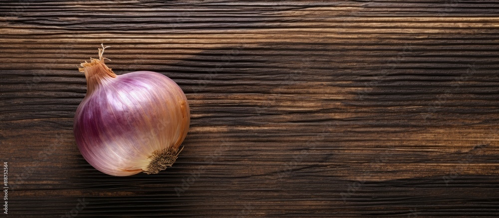 Poster A top down view of a Crimean sweet onion placed on an aged wooden surface creating an appealing copy space image