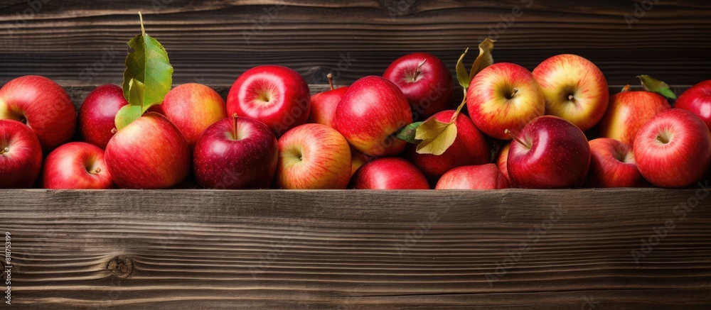 Poster A box filled with ripe apples sits on a rustic wooden background providing ample copy space