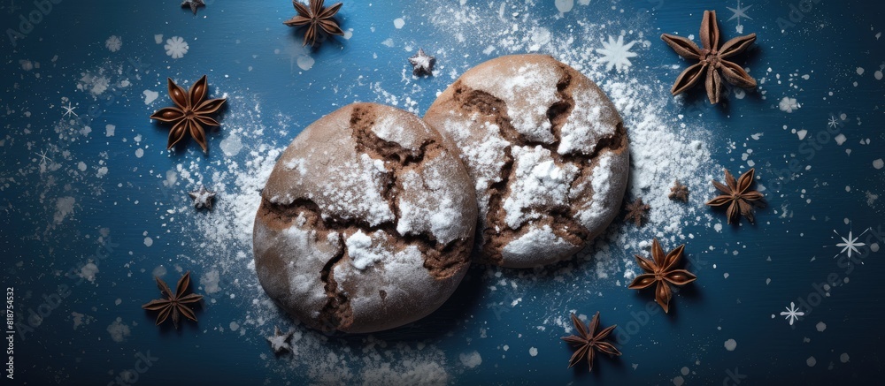 Poster top view of homemade bakery chocolate cookies with powdered sugar and star anise on a blue napkin id