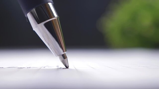 Signing document with pen. Ballpoint pen, extreme close-up view