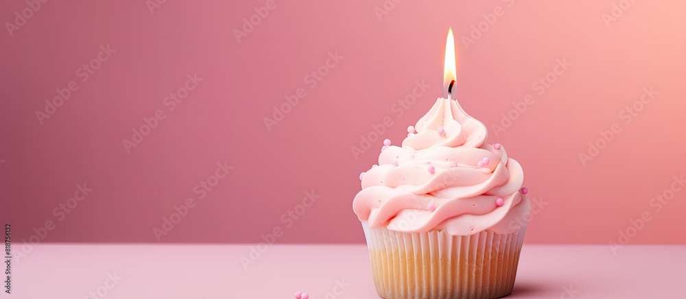 Poster a birthday cupcake with buttercream icing and a candle set against a pink pastel background there is