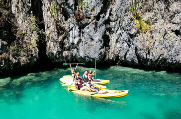 Group of happy people on a kayaks in the bay of lagoon 