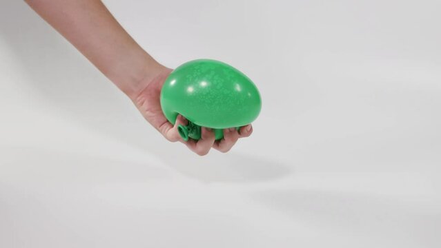 Squeezing Green Water Balloon