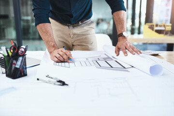 Architect, hands and blueprint on table for drawing, sketch and construction design in office....