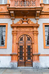 close up of intricately carved wooden door with decorative elements on historic building facade