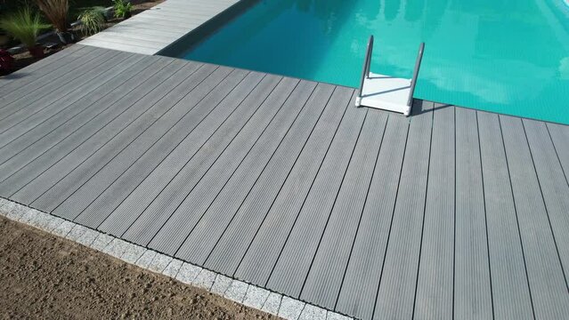 Composite Deck Next to Backyard Swimming Pool