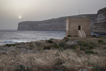 Tranquil scenery of Xlendi Tower in Xlendi Bay in Malta