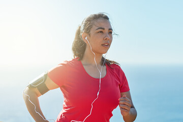 Female athlete, headphones and running in sunshine with music for race, mission for health or...