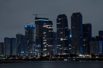 Fototapeta premium City skyline at night with tall buildings near the ocean in Wuhan, China