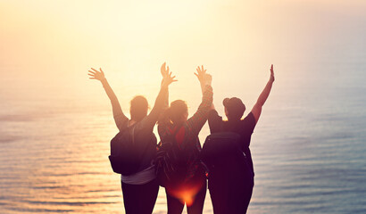 Friends, fitness and hands in air at beach sunset for freedom, peace and fitness with sea...