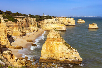 The beautiful Marinha beach at Praia da Marinha, with its spectacular sea stacks and cliffs, in the...