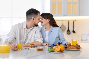 Happy couple spending time together during breakfast at home