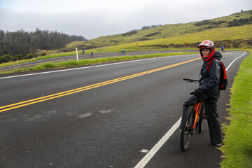 Obraz premium a person is standing on a bicycle with a helmet on