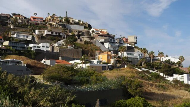 Mountain houses of Canico with blue cloudy sky in Madeira Island, Portugal