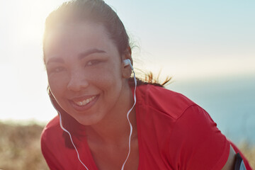 Flare, woman and headphones in portrait for run in rest outdoor with music, listening and smile for...