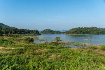 Kraeg Krachen National Park headquarters view to the lake with grass and wetlands and suspension bridge.