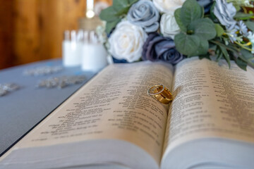 Pair of wedding bands on the open pages of the Bible