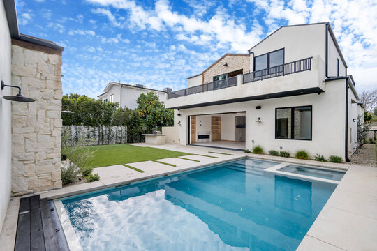 a white house with a swimming pool in the front yard
