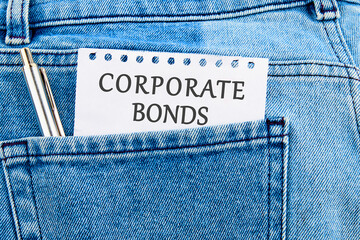 Finance and economics concept. CORPORATE BONDS written on a piece of paper that appeared from the...