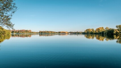 Obraz premium Scenic autumn lake surrounded by trees, Cergy, France