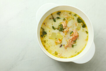Finnish creamy soup with salmon on the wooden table