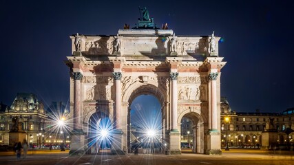 Fototapeta premium City skyline with illuminated Arc de Triomphe on a chilly evening