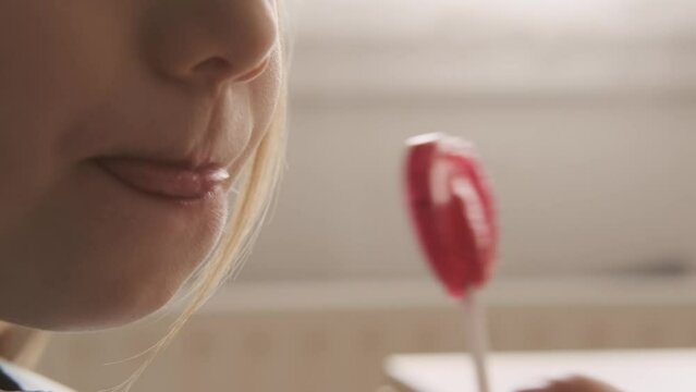 cute small child, blonde girl 5 years old enjoys sweets, close-up face, lollipop in hand, happy childhood, balanced diet, sweet life, unhealthy food, halal food, sugary treat, Child Nutrition - Powered by Adobe