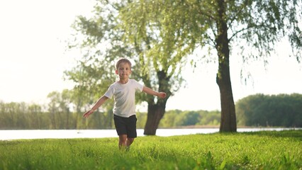 The kids run and play in the park. happy family kid dream concept. The kids from nature run...