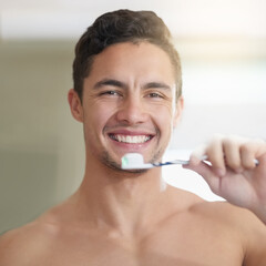 Dental care, portrait and man brushing teeth with smile in bathroom for hygiene, cleaning or...