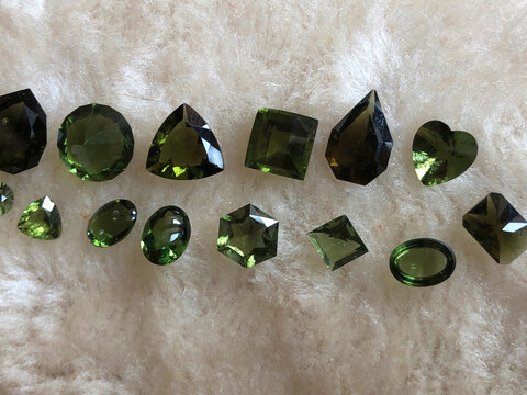 Different shaped faceted moldavite gems