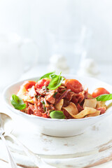 Spaghetti Pasta with Vegetables and fresh Basil on bright wooden Background.	