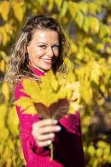 Naklejka premium Happy woman enjoying autumn life in the nature