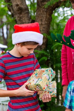 Aussie kids holding Christmas gifts received from family