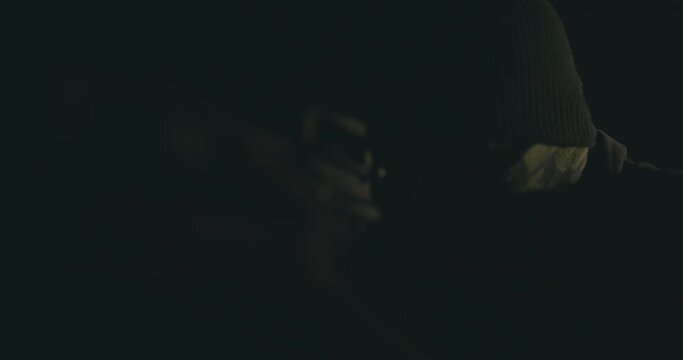 Masked gunman wielding a rifle