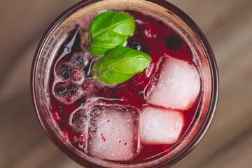 fresh raspberry lemonade with mint leaves, ice and currant pieces