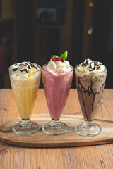 ice cream cups with different flavors, vanilla strawberry and chocolate