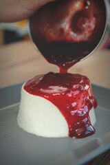 panna cotta topped with cranberry sauce