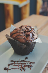 chocolate muffin with chocolate sauce on top