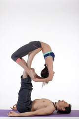 Naklejka premium People practicing acro yoga in photo studio. Acro yoga sport theme concept.