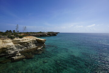 Areal view of The Anguilla Arch merging with the azure waters