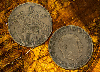 Close-up of a Spanish peseta coin against a black background