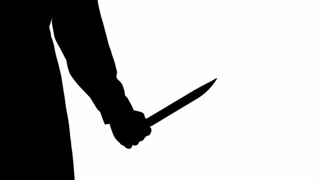 Black silhouette of a male maniac with a large sharp knife in his hand. Unrecognizable man on white isolated background.