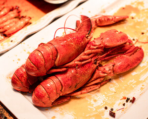 Brightly colored Chinese lobster illuminated by warm lights, bursting with delectable flavors