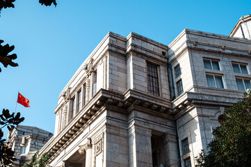 Vintage architectural structure featuring multiple windows and a balcony