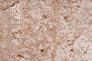 Ancient wall with historic inscriptions etched into it