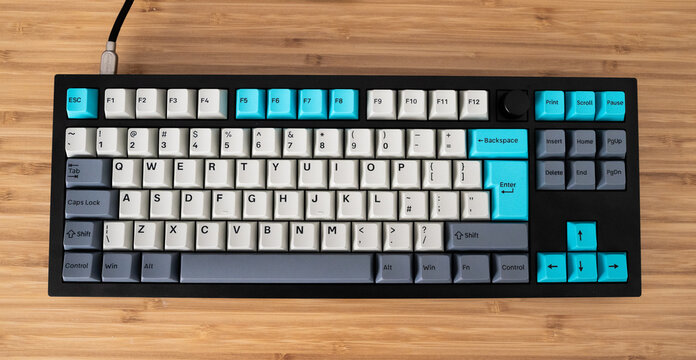 Mechanical custom keyboard on a wooden table.