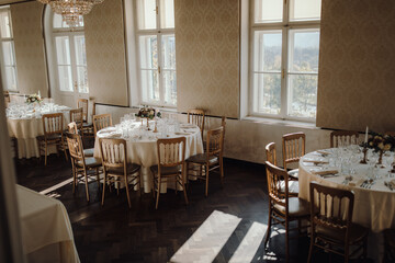 the wedding reception table is decorated with flowers and candles and chairs