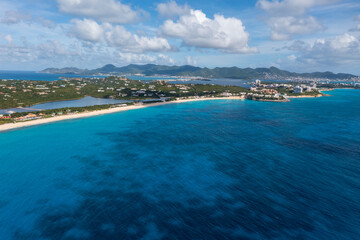 a view of a beautiful island in the ocean with a beach and mountains