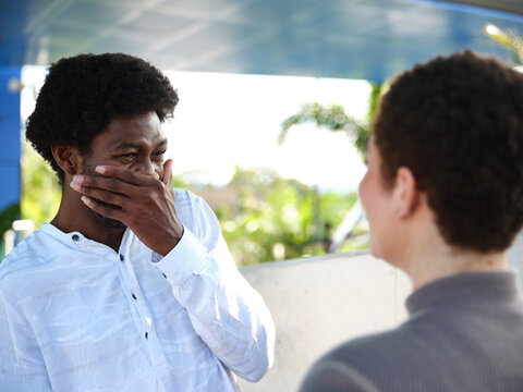 Man and woman sitting having a conversation outside